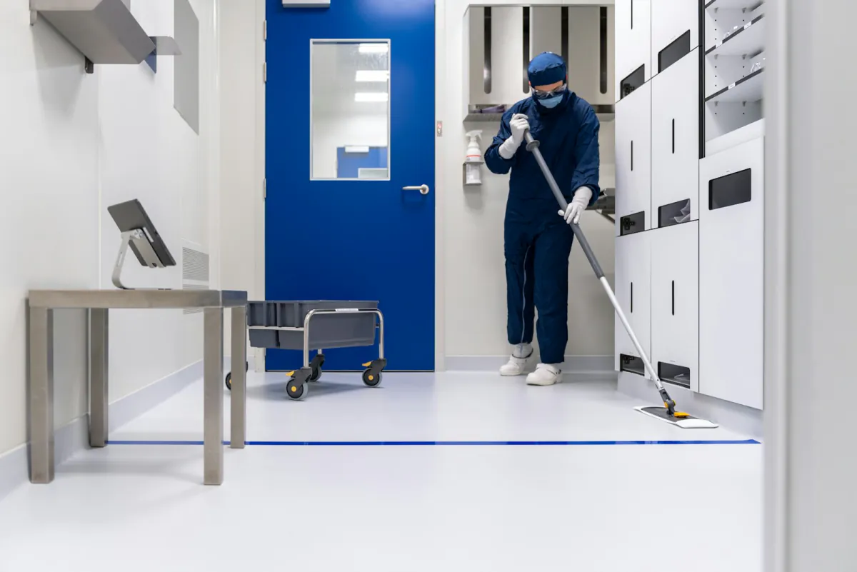 Uniformed technician finishing up in a clean home interior