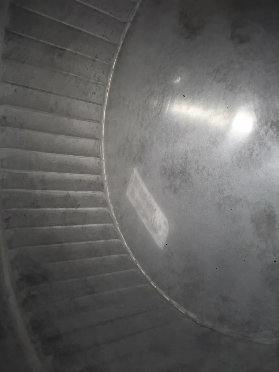 Close-up of a metal furnace air duct interior during cleaning
